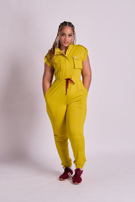 Woman wearing a yellow jumpsuit on a plain background